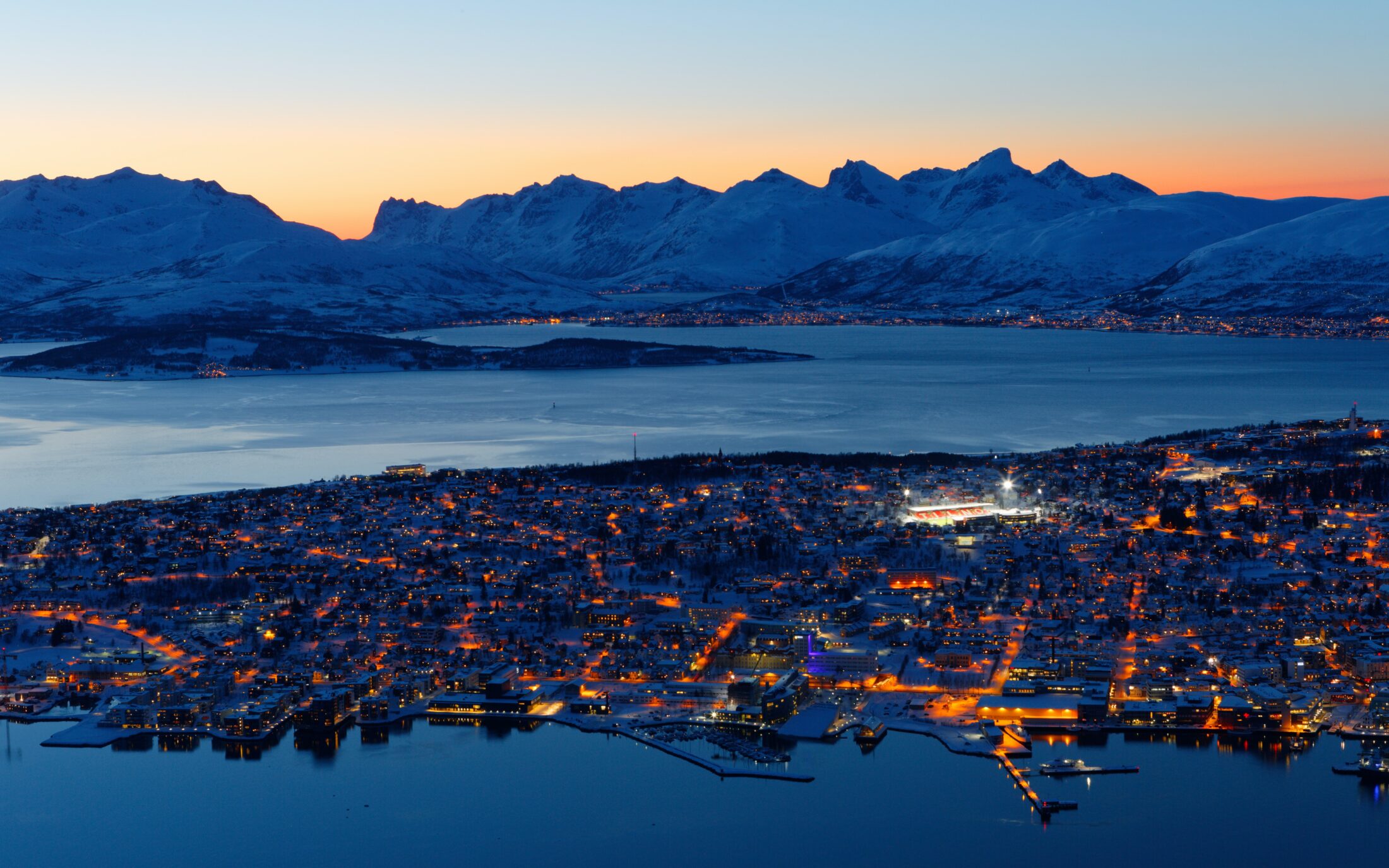 Aerial view of Tromsø, Norway at night. Photo by Harry Jaschhof on Unsplash.